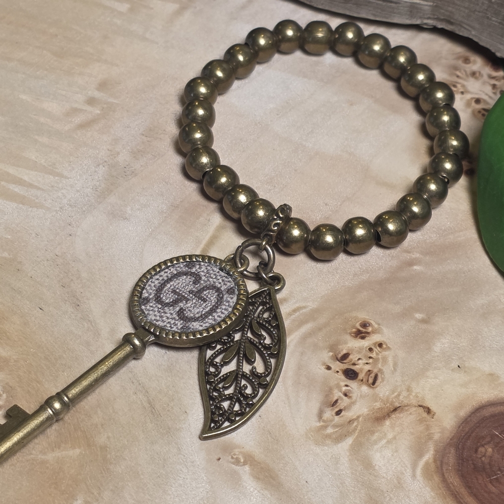 Upcycled Antique Gold Beaded Bracelet with Key and Leaf Charms